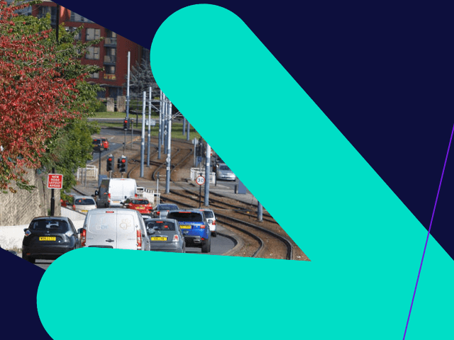 Busy road in Sheffield next to tram tracks