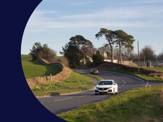 Cars on road in rural Cumbria