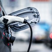 Electric Vehicle is changing in street.
