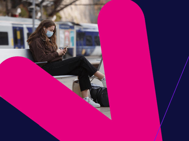 Female in mask on phone at station