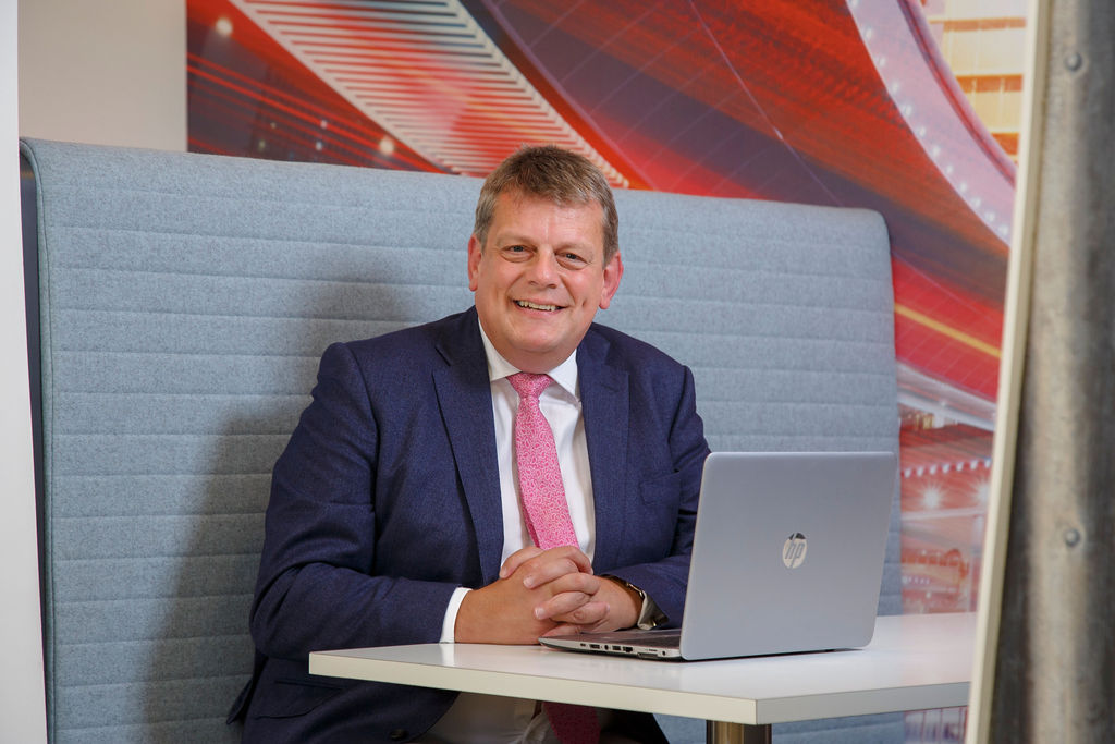 Martin Tugwell at desk with laptop