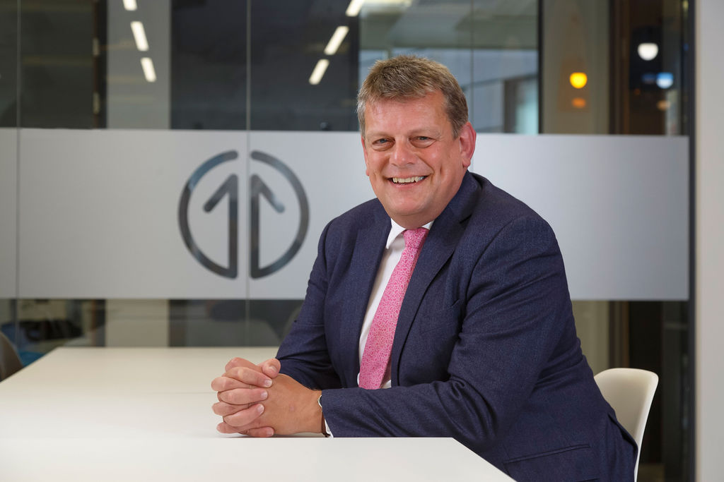 Headshot of Martin Tugwell with Transport for the North logo