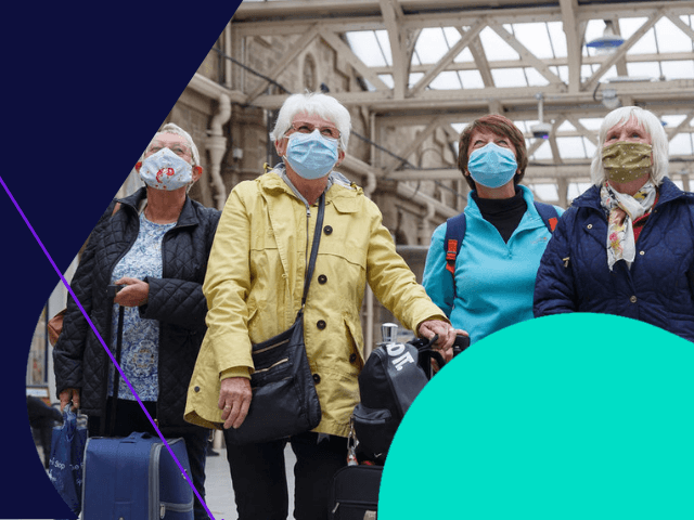 Female at Sheffiel station wearing mask looking at information board