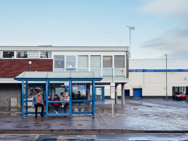 Family sitting at a bus stop in Blyth