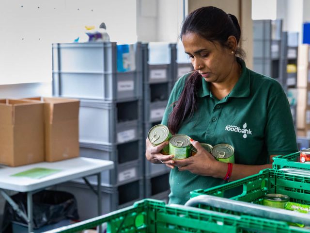 Trussell volunteer making a parcel