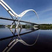 train passing over futuristic bridge