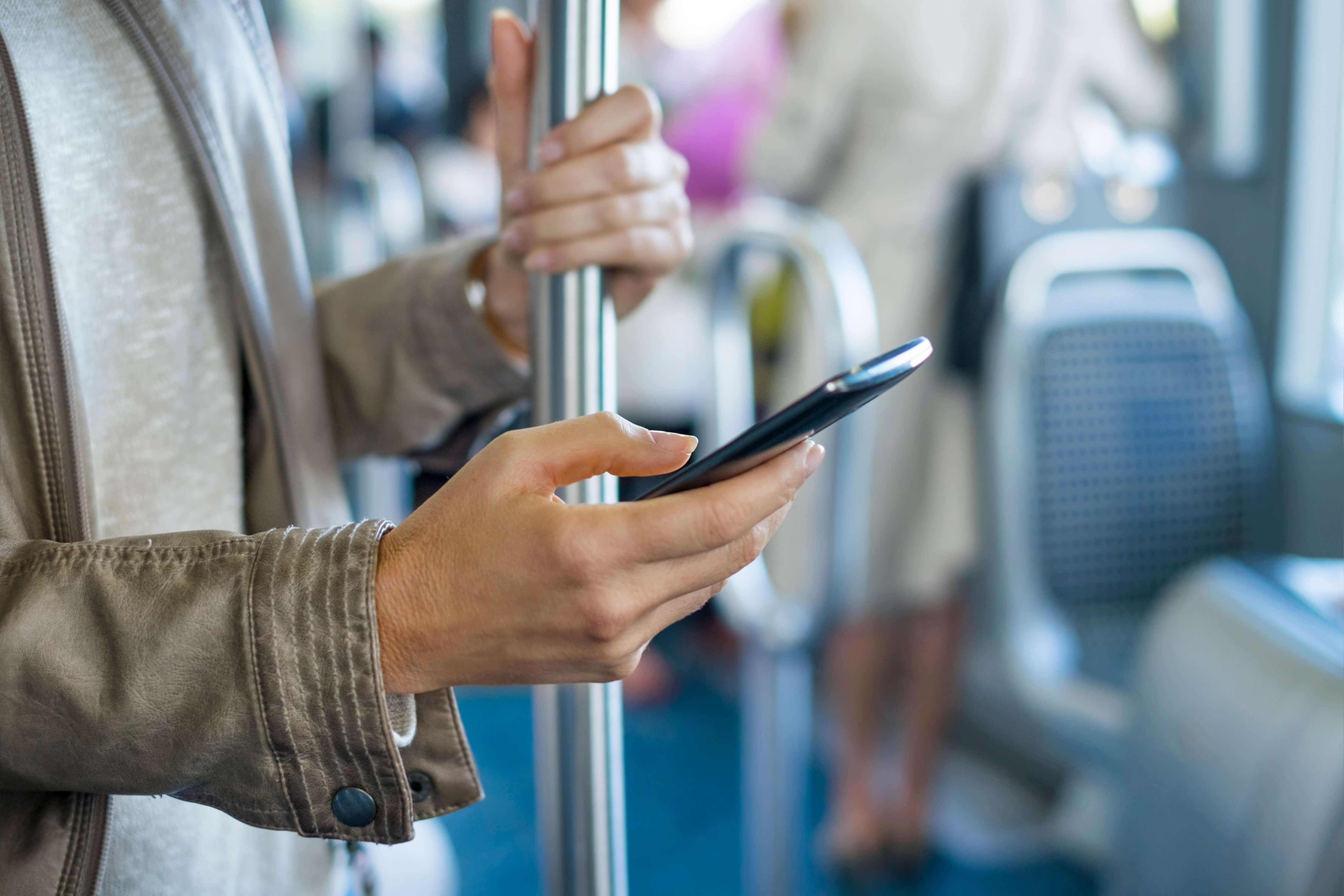Smart phone being used on a bus